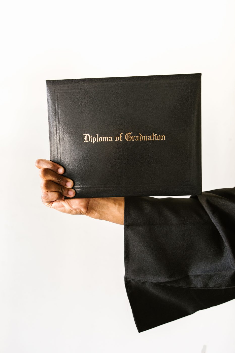 A graduate holding a diploma of graduation